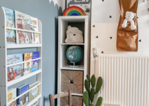 toy room with hanging wall storage and kallax ikea bookshelf tucked in corner