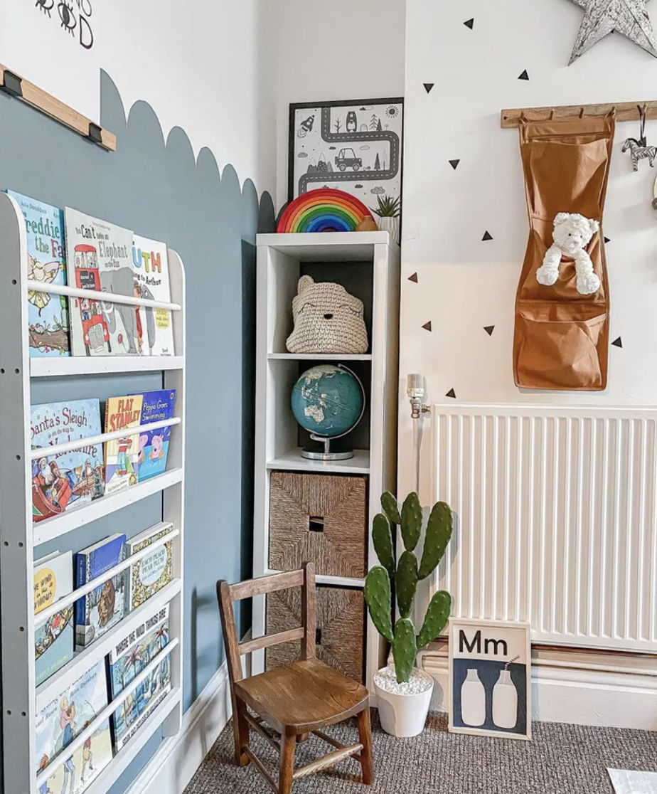 toy room with hanging wall storage and kallax ikea bookshelf tucked in corner
