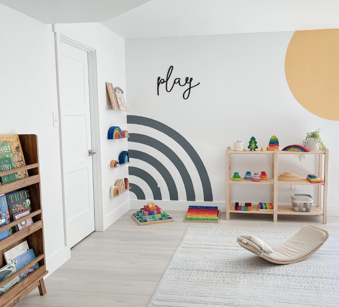minimalist style toy room with neat shelf and bookcase the word play on the wall with geometric design