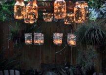 mason jar chandelier with fairy lights lit up at night