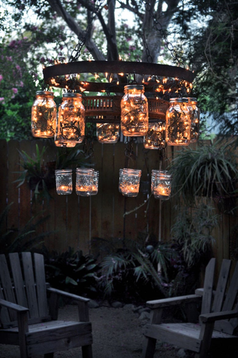 mason jar chandelier with fairy lights lit up at night