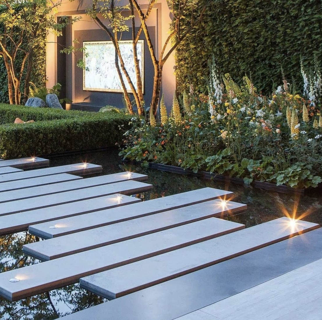 modern flat cement garden steps walkway with lit up landscape lighting.