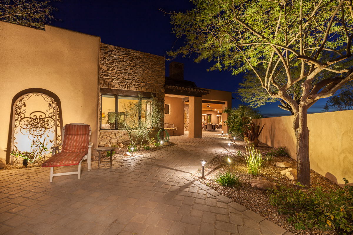 pathway lighting outside of stone house tree lounge chair