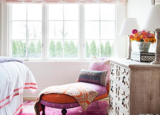 pink orange and purple theme bedroom with chaise lounge wood dresser roman blinds big window