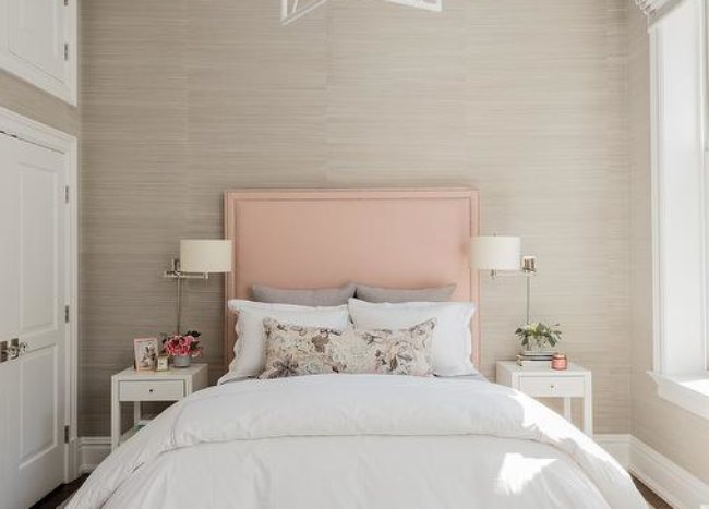 pink and grey white beige bedroom with large double bed nightstand with lamps