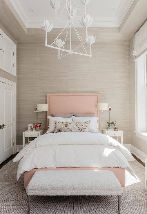 pink and grey white beige bedroom with large double bed nightstand with lamps