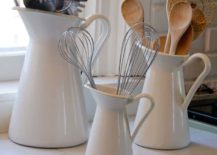 white pitchers with wooden spoons on kitchen counter