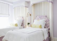 purple and yellow twin beds with valance and curtains behind