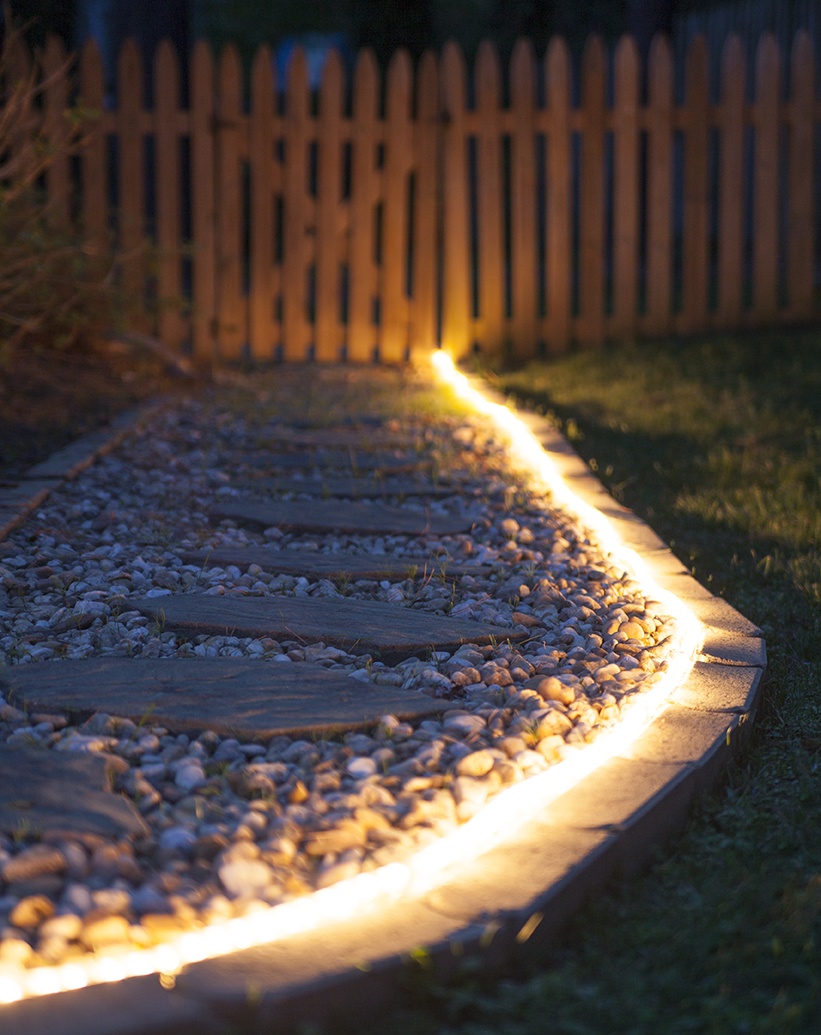 lit rope lighting garden walk way at night