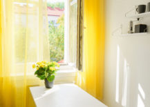 Window at the kitchen with bright yellow curtains. Positive colors. Illuminating yellow. Stress reducing concept. Comfort zone. Interiors