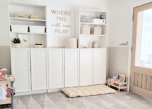 white ikea bookshelves used in kids toy room with decorative saying on the wall