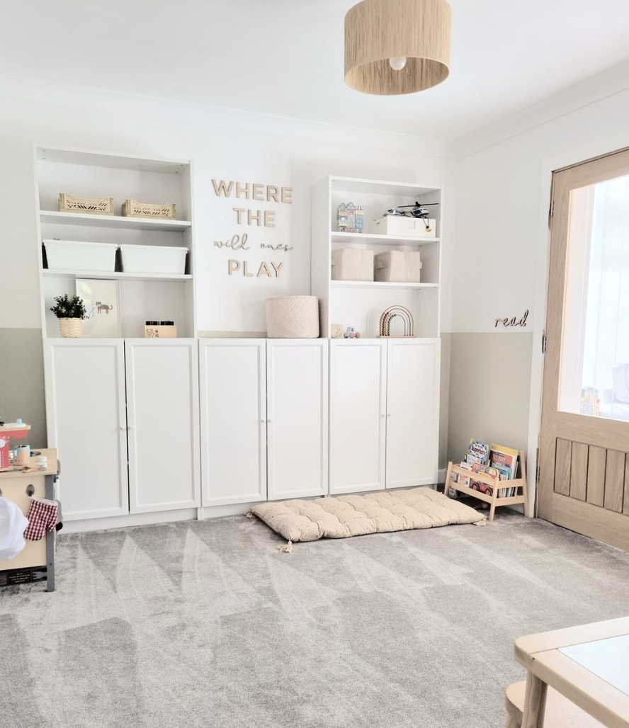 white ikea bookshelves used in kids toy room with decorative saying on the wall