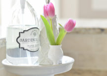 white soap stand in kitchen with clear glass soap bottle pink tulips