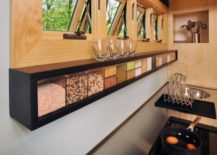 black skinny counter hanging spice storage with wood windows above