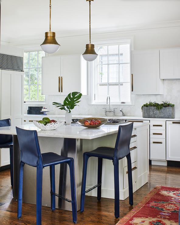 blue stool chairs at square island in white kitchen