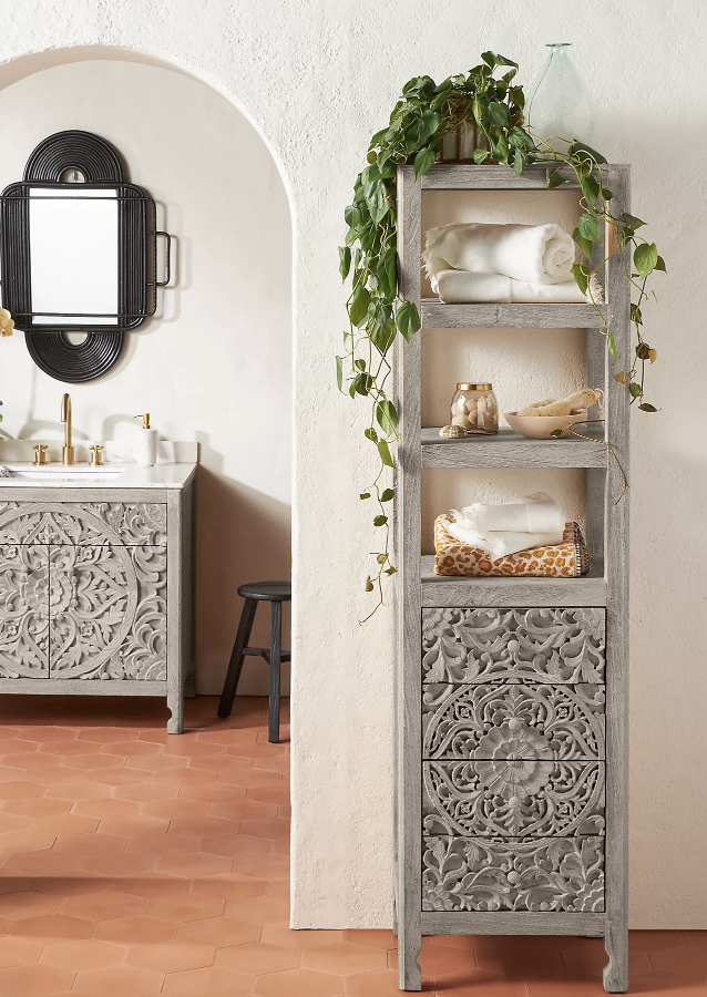 grey wood washed storage shelf with greenery on top towels