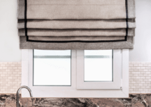 textured roman shade close up in kitchen with white tile and marble counter