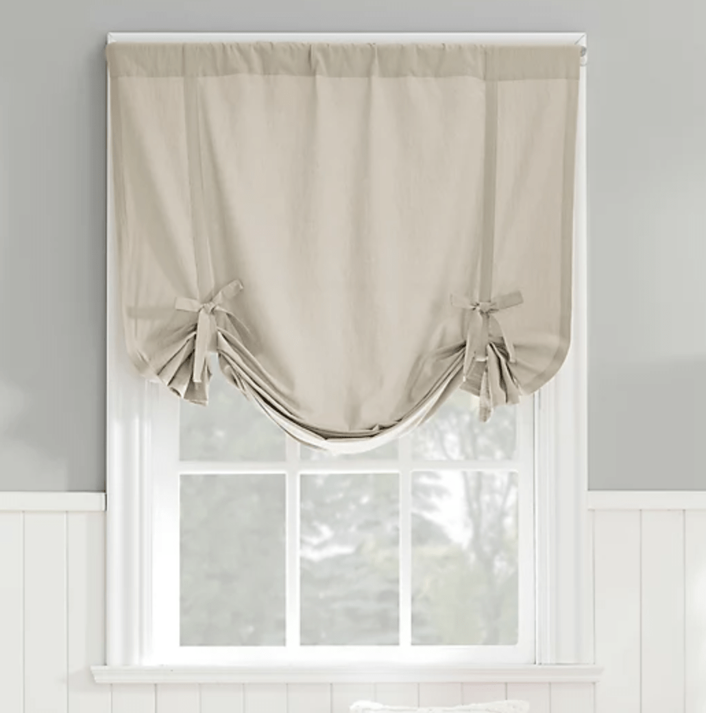 tie up beige gray window valance on white window with grills board and batten wall
