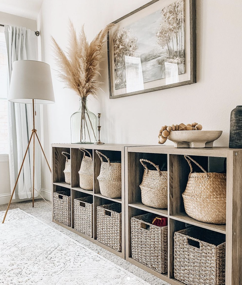 wood cubby basket shelf in white living room with pampas grass in sea glass vase on top wood beads white standing floor lamp