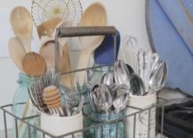 wire utensil caddy with wooden spoon and silverware blue mason jars