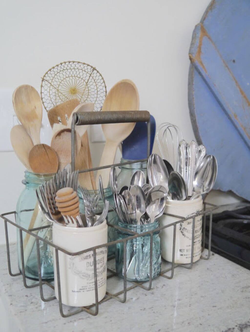 wire utensil caddy with wooden spoon and silverware blue mason jars