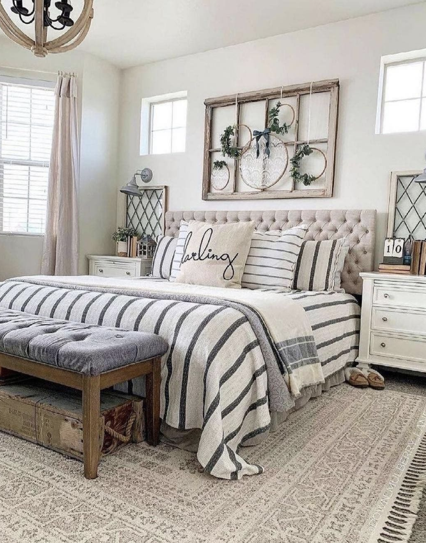 large master farmhouse bedroom with old window above bed tufted headboard decorative throw pillows