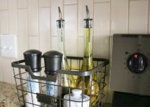 wire basket next to stove with oil bottles and salt and pepper