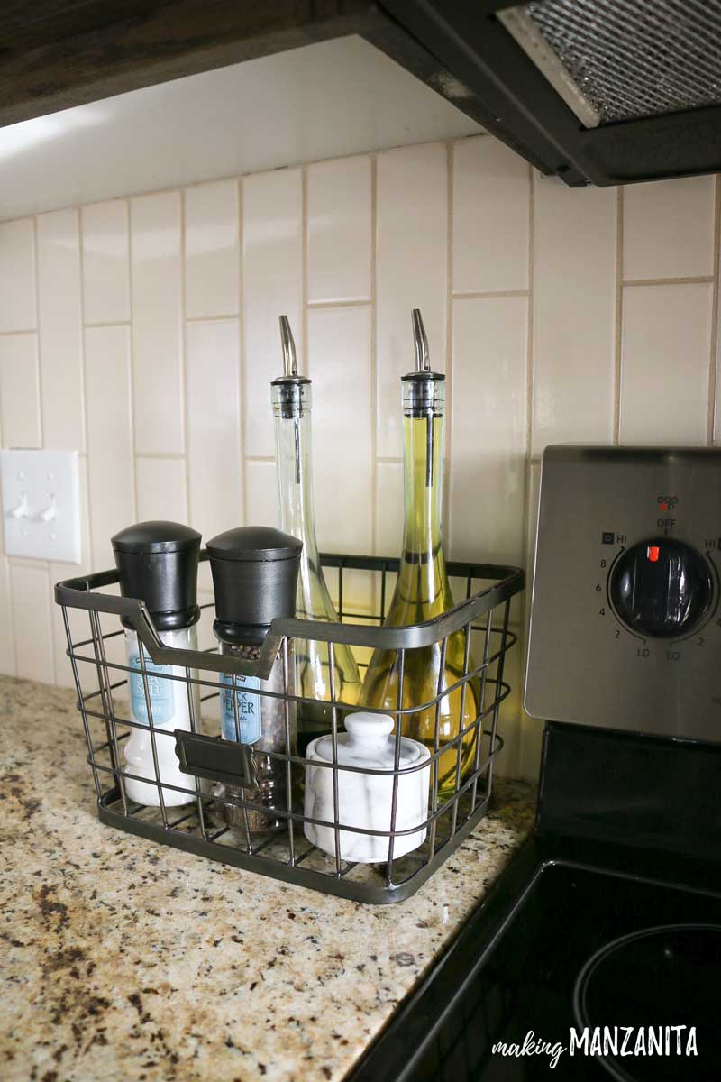 wire basket next to stove with oil bottles and salt and pepper