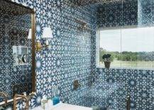blue mosaic tiles floor to ceiling walk in shower with frameless glass doors gold faucet white counter sink gold mirror wall sconce