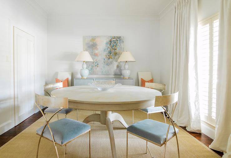 blue velvet chairs around round dining table