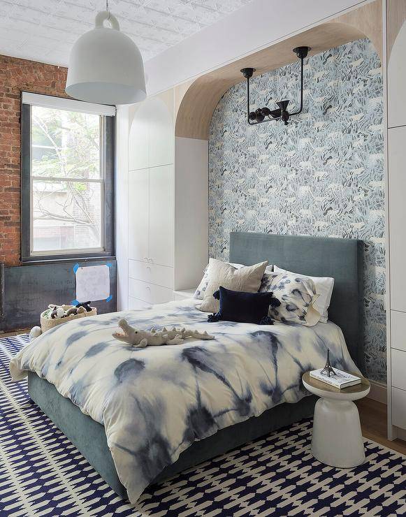 blue wallpaper in nook bed with velvet headboard brick accent wall white hanging pendant