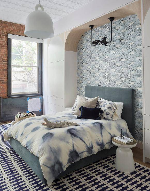 blue wallpaper in nook bed with velvet headboard brick vocalizing wall white hanging pendant