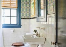 half bathroom with color framed window blue pedestal sink with bold wallpaper