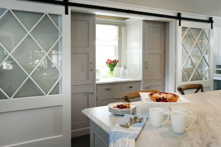 photo of white sliding doors open and revealing a butler pantry