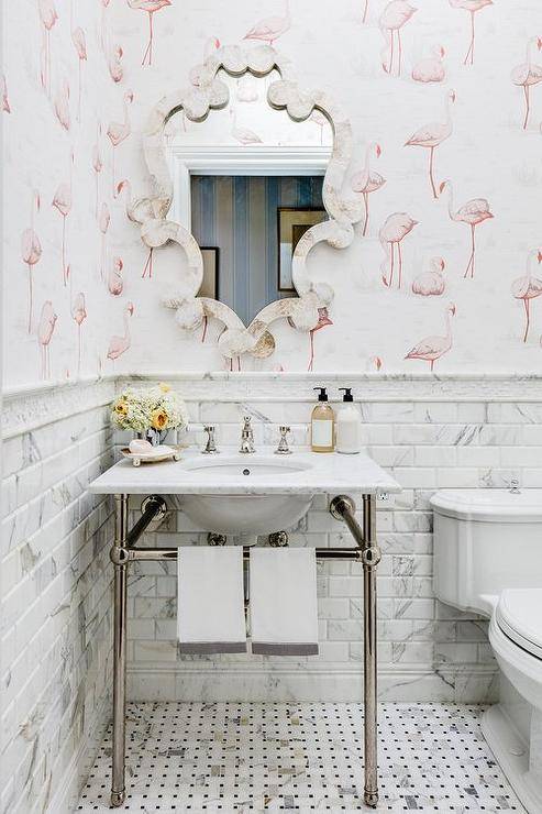 flamingo wallpaper in half bathroom with decorative scroll mirror and pedestal sink