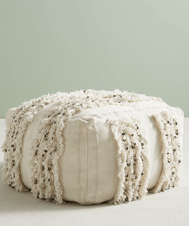 white floor pouf light green background