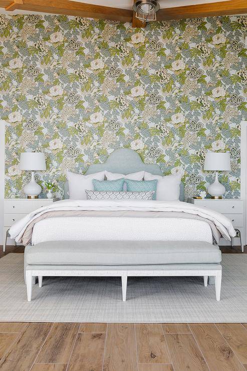 floral wallpaper blue and white queen bed with blue headboard nightstands and table lamps