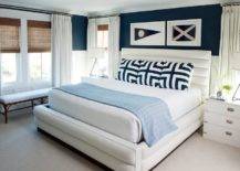 framed nautical flags hanging over bed white and blue bedding cottage style bedroom