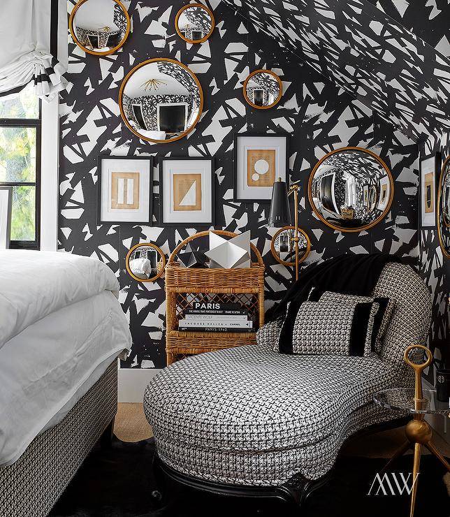 black and white bold wallpaper in bedroom with gold mirros and gallery wall chaise lounge white bed