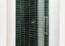 green subway tile walk in shower with glass door