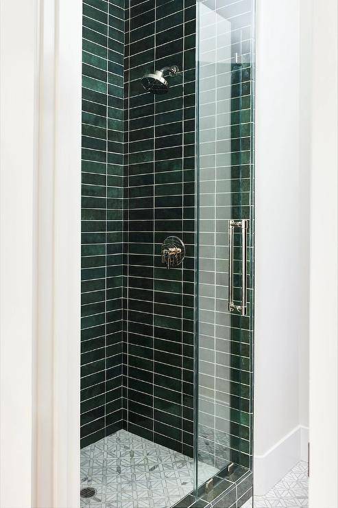 green subway tile walk in shower with glass door