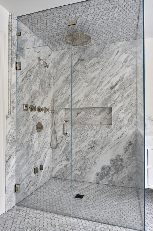 grey marble walk in shower with circle floor tiles chrome shower kit floor to ceiling glass doors