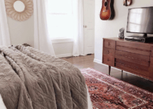 hanging guitar and violins in bedroom on white walls mirror television