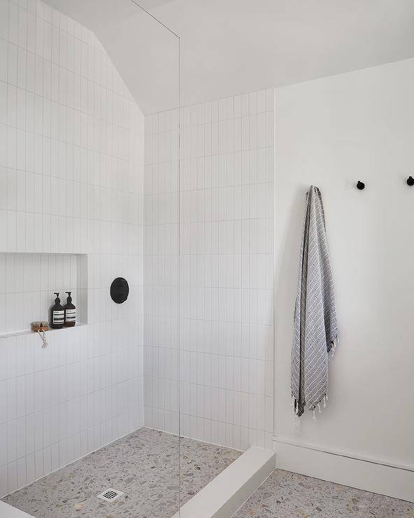 modern white simple walk in shower towel hanging on wall and soap inside shower wall