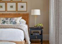 rattan wicker bed headboard neat art frames above bed gallery wall blue nightstand with tall lamp
