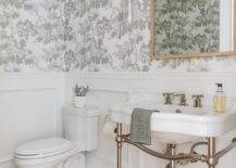 half bathroom with floral grey wallpaper polished nickel pedestal sink toilet gold square frame mirror wall sconce