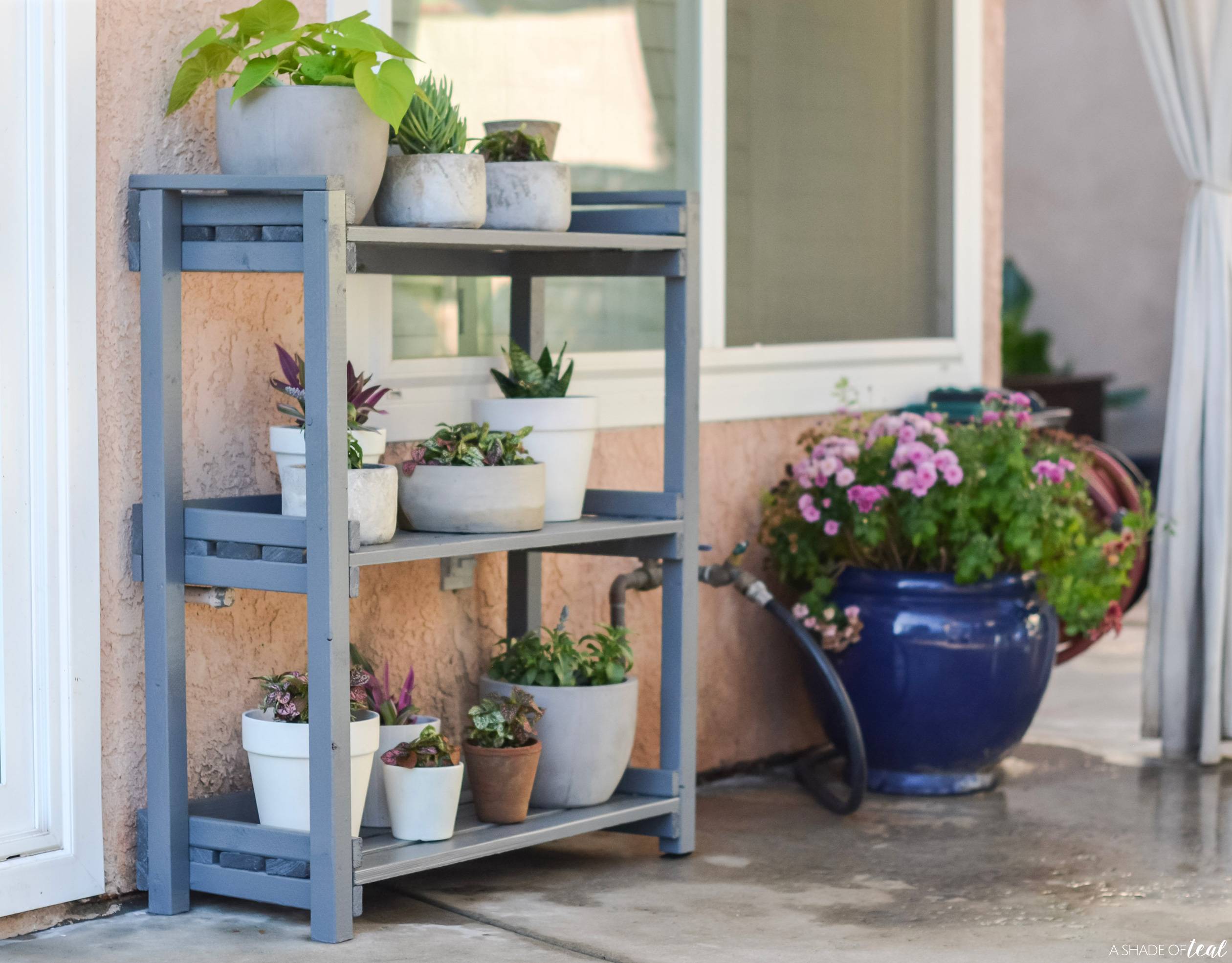 blue plant stand diy outside with white pots on it