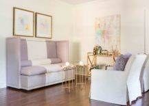 purple pastel couch with white sitting chairs and gold tables