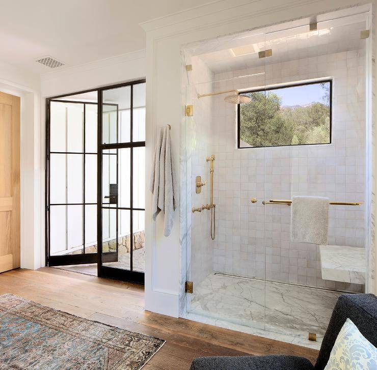 square white tile in walk in shower gold shower kit with marble bench black frame window in shower black frame glass doors
