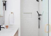 modern white walk in shower with black shower kit white counter vanity and patter mosaic floor tile